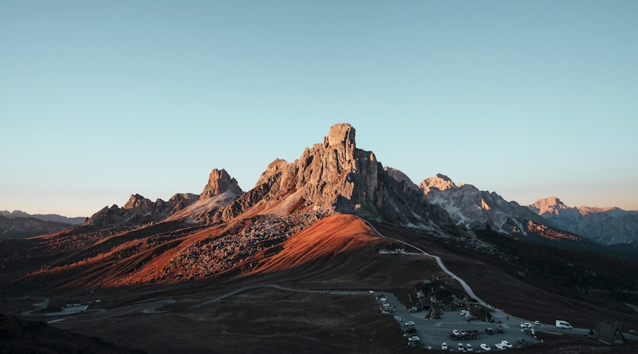Two paddlers in dry suits on a spring river with high water and bare trees along the banks