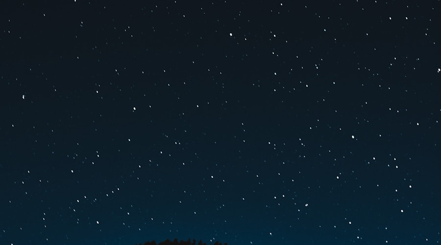Couple walking along a beach at sunset with golden light reflecting on wet sand